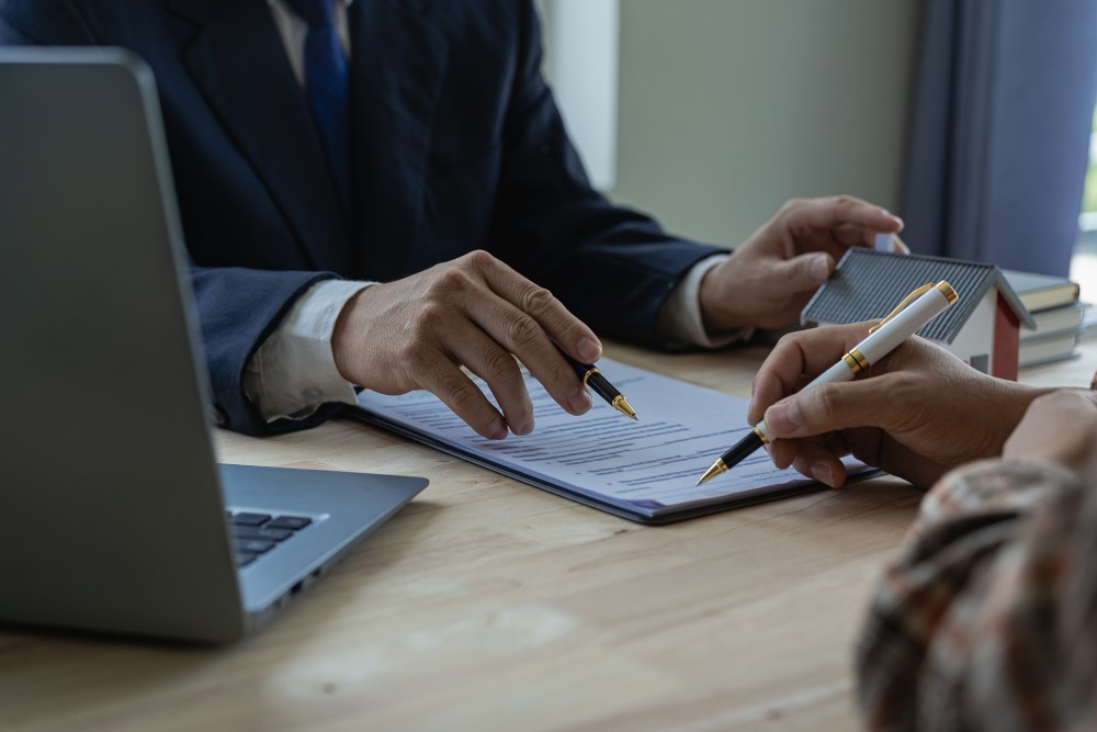 Homeowner signing a coverage a insurance policy