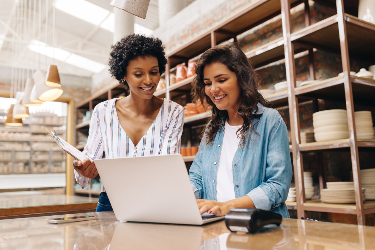 Business owners reviewing their business personal property in their store on a laptop
