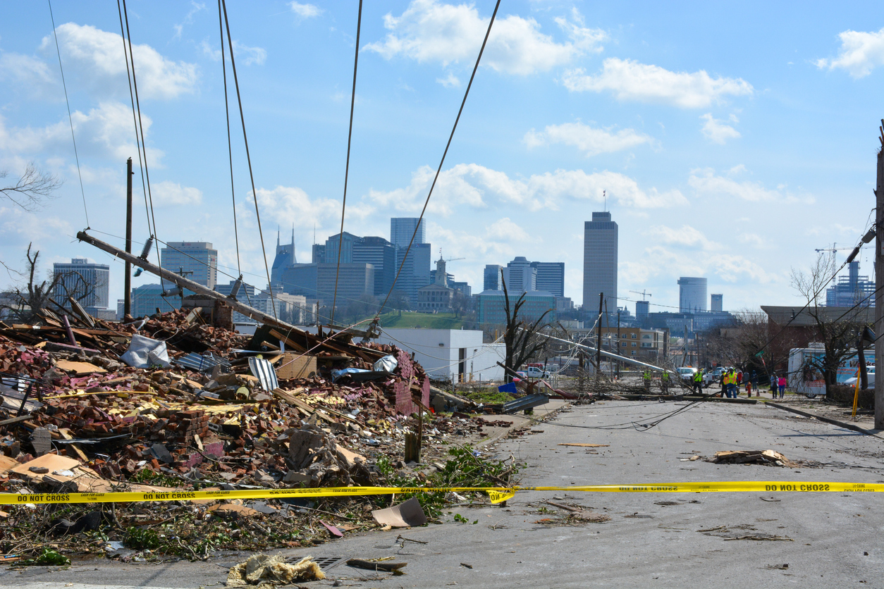 Debris in a Nashville street after a tornado. City skyline can be seen in the distance.