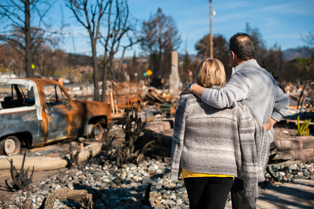Couple looking at a destroyed property