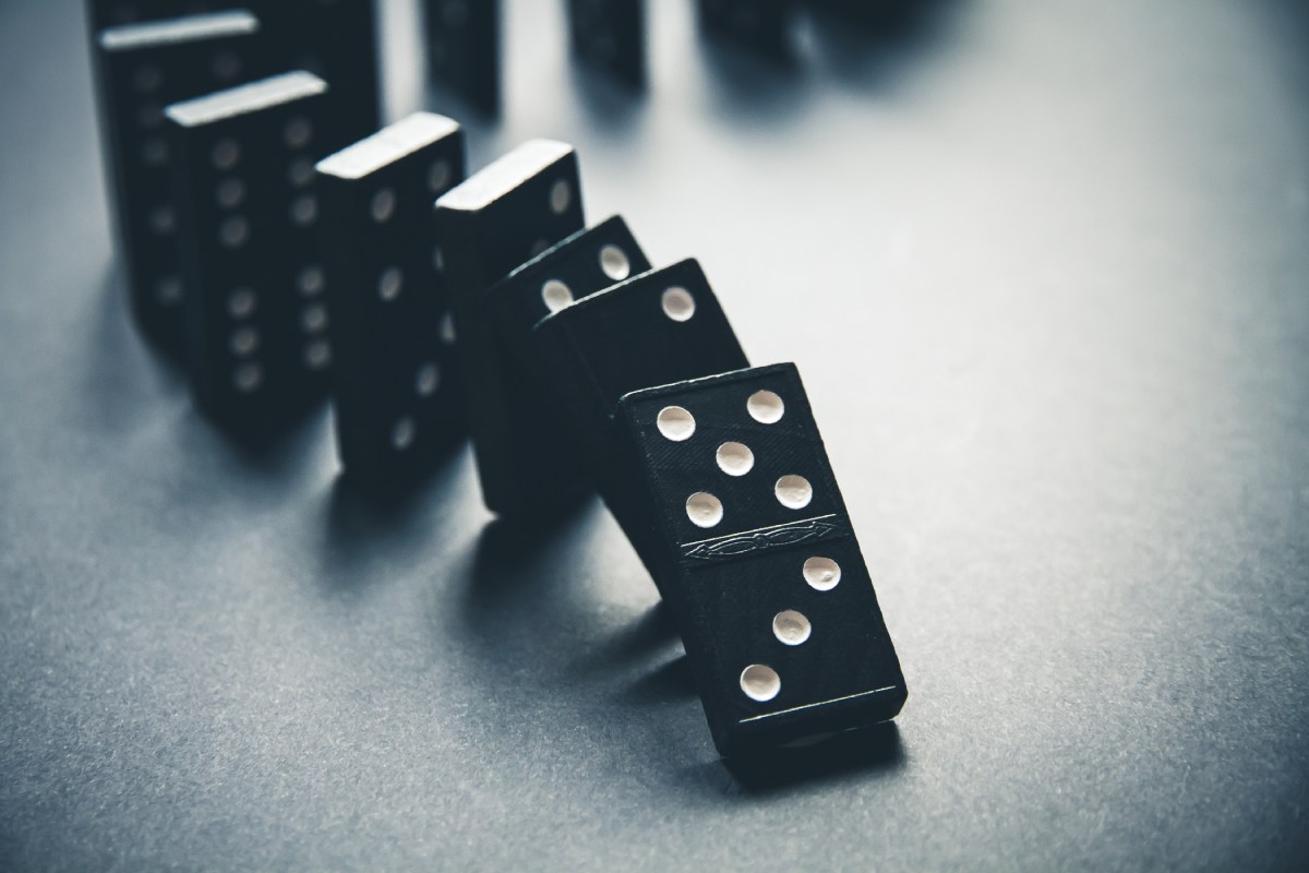 An image of dominoes in the process of falling down meant to represent consequential damages